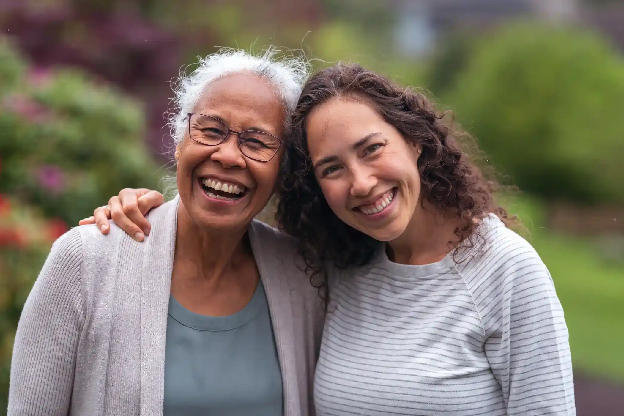 Mother and daughter hug while posing for a picture